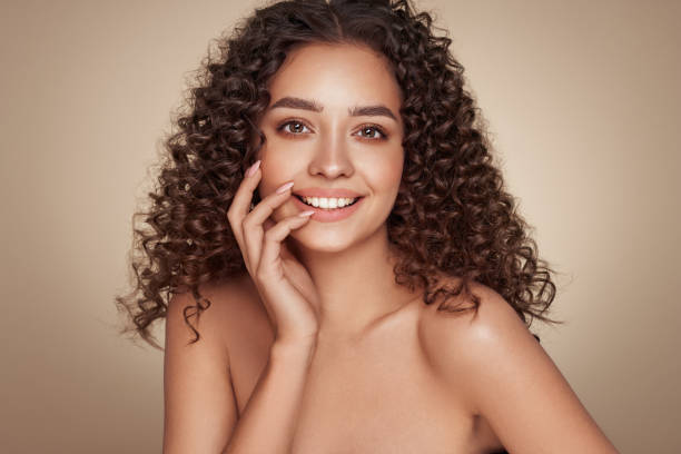 istock Beautiful smiling woman with afro curls 1395309808