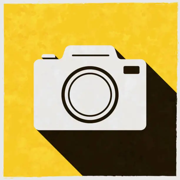 Vector illustration of Photo camera. Icon with long shadow on textured yellow background