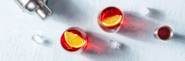 istock Campari cocktail with fresh oranges, a jigger and a cocktail shaker, overhead 1395310031