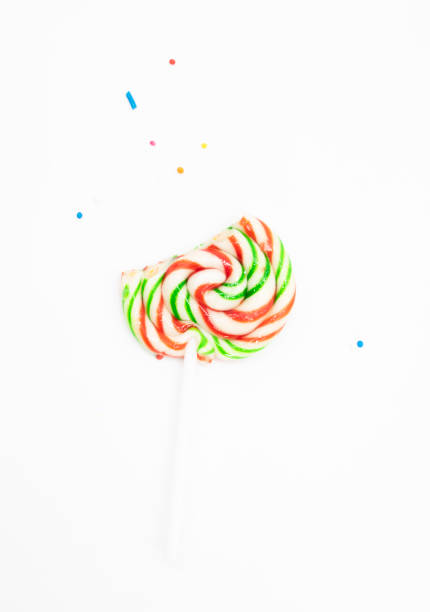 istock Colorful candy with sprinkles on a white background. Lollipop. Top view 1395312096