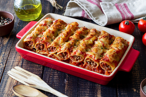 Cannelloni with meat, cheese, tomatoes and thyme. Italian cuisine