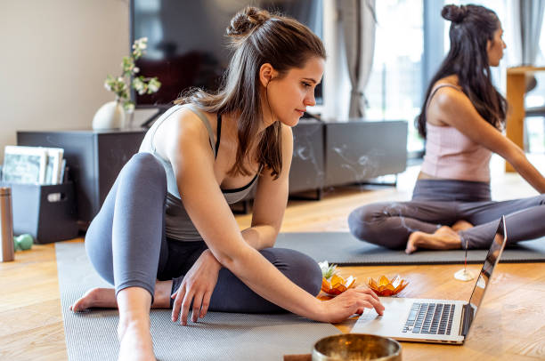 istock Two women practicing yoga at home 1395312500