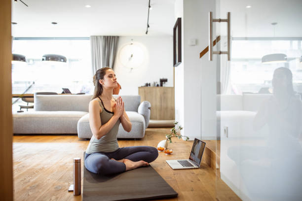 istock Woman practicing yoga at home 1395312566