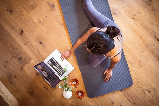 istock Woman practicing yoga at home 1395312633