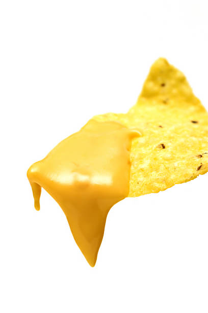 nacho chip with cheese a tortilla with hot nacho cheese dripping off the end nachos stock pictures, royalty-free photos & images