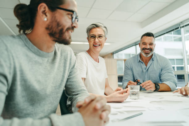 istock Cheerful architects working together in a modern office 1395314431