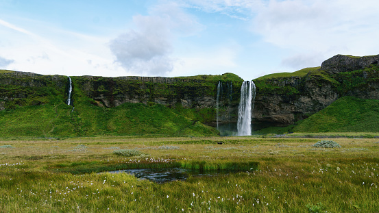 Seljalandfoss waterfall on Seljalandsa river. Summer landscape. Iceland, Europe. Horizontal background, copy space.