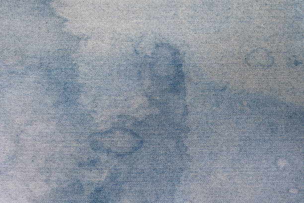istock Close up of fabric texture with blue stains 1395317025