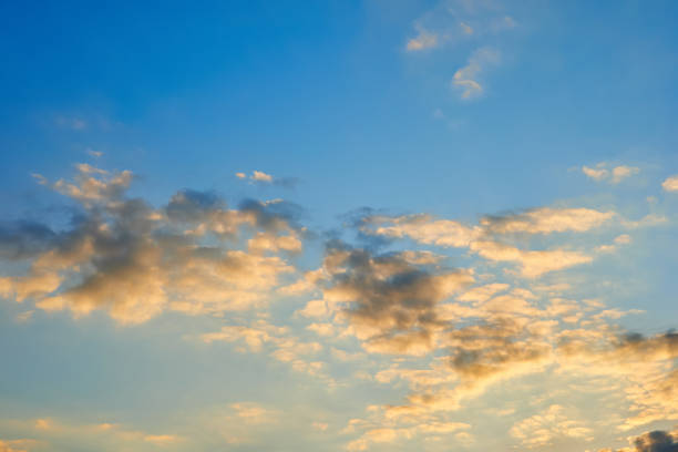 istock Orange clouds in the blue sunset sky 1395317594