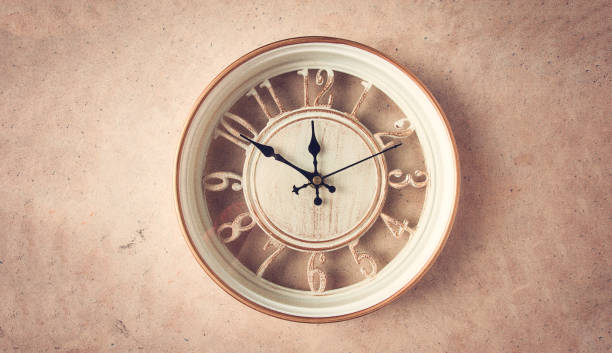 istock Mechanical wall clock, transparent , beige color , on a light painted wall, rustic style, vintage, no people, 1395318740