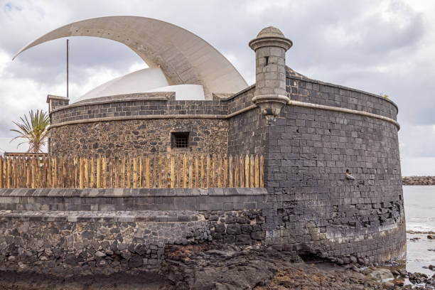 The Castle of St John the Baptist also called the Black Castle from 1644 with a view to Auditorio de Tenerife which is designed by the architect Santiago Calatrava (born 1951) was finished in 2003 and are situated close to the harbor of Santa Cruz which is the main city on the Spanish Canary Island Tenerife