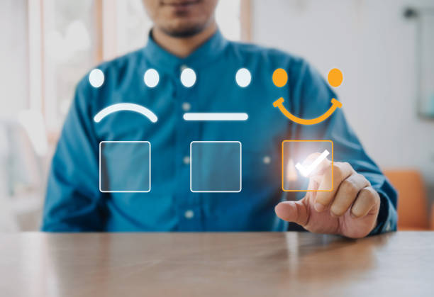 istock Businessman using a smartphone And she is pressing face emoticon smile in satisfaction on virtual touch screen. Customer service evaluation concept. 1395320757