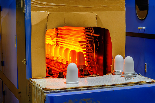 Furnace for making lampshades. Close up of processed molten glass. Light factory