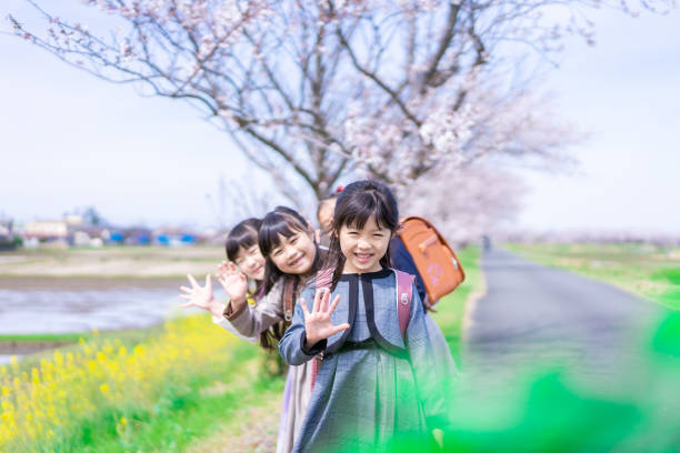 istock Elementary school students carrying school bags to school 1395321125