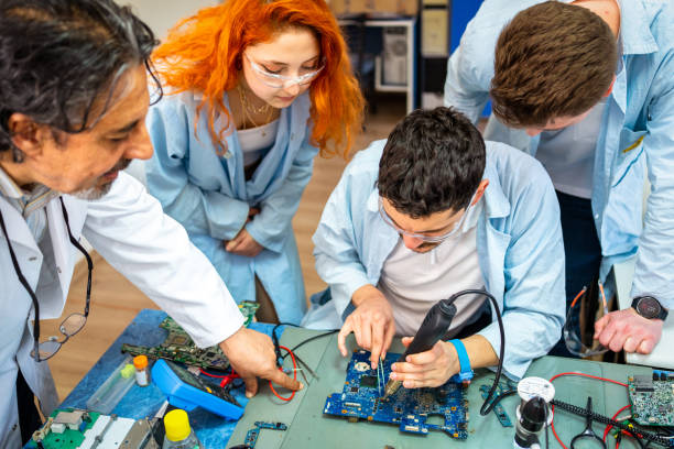 Group of young people in technical vocational training with teacher Group of young people in technical vocational training with teacher high school high school student science multi ethnic group stock pictures, royalty-free photos & images