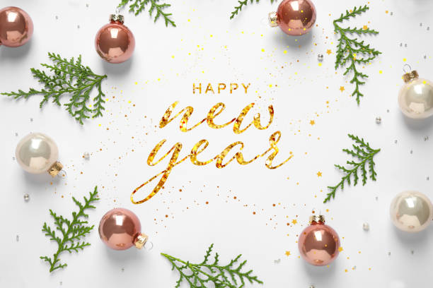 istock Happy New Year! Flat lay composition with baubles and green branches on white background 1395322227
