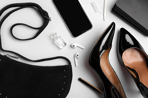 Flat lay composition with stylish woman's bag on light background