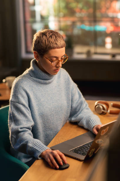 istock Vertical Screen: Young Attractive Woman Using Laptop Computer in Stylish Loft Apartment During the Day. Creative Female Checking Social Media, Browsing Internet, Wearing Cozy Clothes. 1395322545
