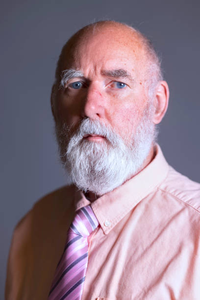 istock Elderly man wearing a pink shirt 1395323713
