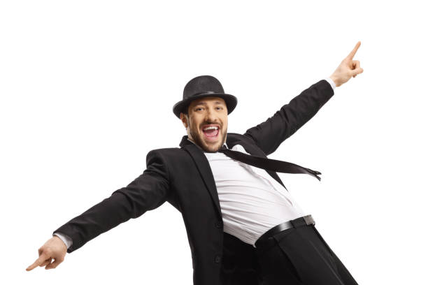 istock Happy smiling guy in a suit dancing and pointing with fingers 1395324127