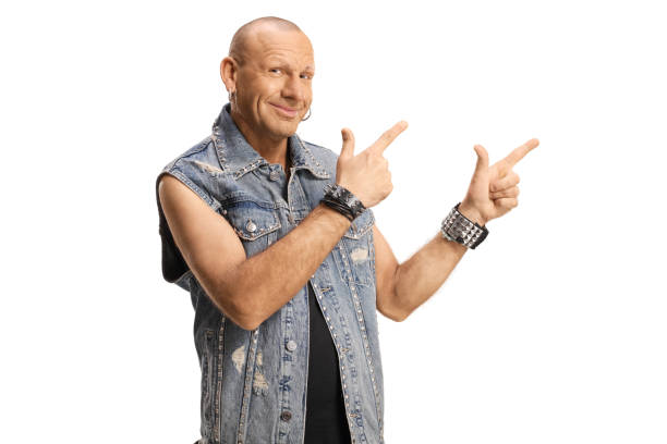 istock Bald man in a denim vest pointing and smiling 1395325063