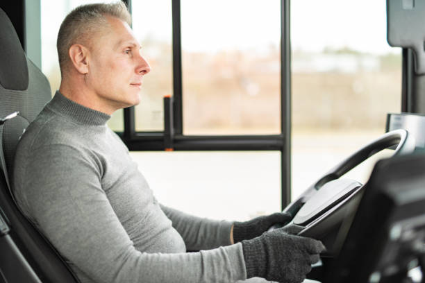 Driver driving a bus stock photo