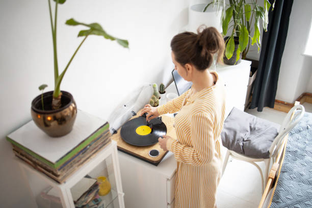 istock Young woman Playing vinyl records 1395325489