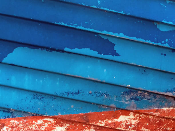 Abstract image of a ship hull in red and blue colors with peeling varnish stock photo