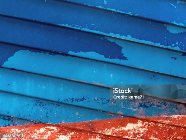 Abstract Image Of A Ship Hull In Red And Blue Colors With Peeling Varnish Stock Photo - Download Image Now