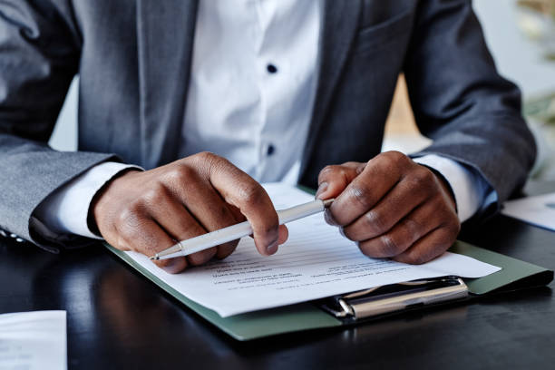 istock Black Executive Holding Pen Closeup 1395329798