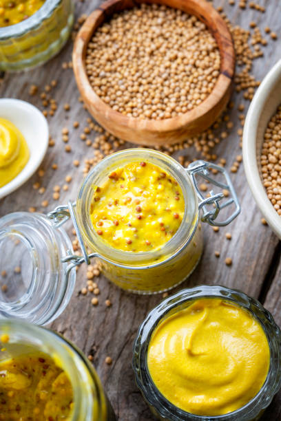 istock Different types of mustard and mustard seeds on a rustic wooden board 1395333173