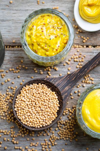 istock Different types of mustard and mustard seeds on a rustic wooden board 1395333781