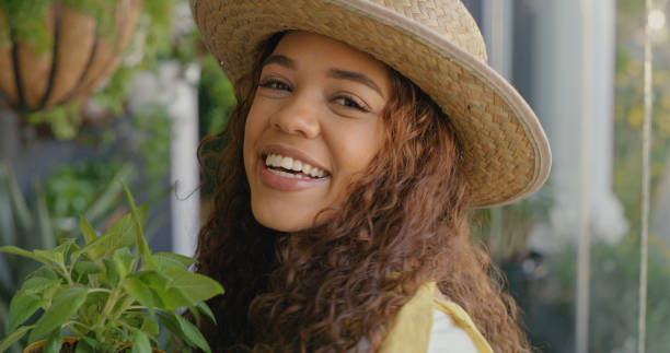 istock Young female florist smiling while working at a nursery 1395333826
