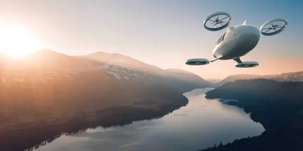 Photo of eVTOL Electric Vertical Take Off and Landing Aircraft Flying Through Beautiful Landscape At Dawn