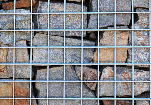 Fence with gabions and stones