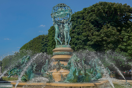 Water spouting around the horses at the base of la Fontaine des Quatre-Parties-du-Monde, also known as Fontaine Carpeaux, built in 1874 in the jardin des Grands-Explorateurs Marco-Polo et Cavelier-de-la-Salle.