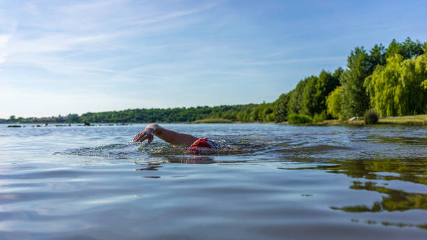 istock Woman swimming in a lake 1395338836