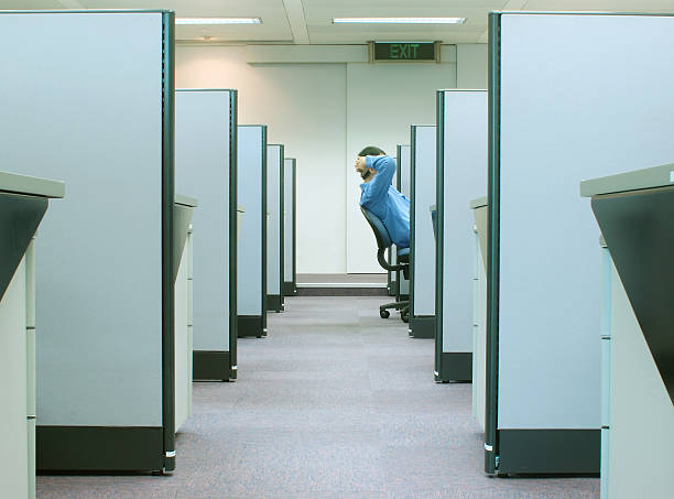 cubicles - office series 2 man reclining on his chair in cubicle with EXIT sign above obscured face photos stock pictures, royalty-free photos & images