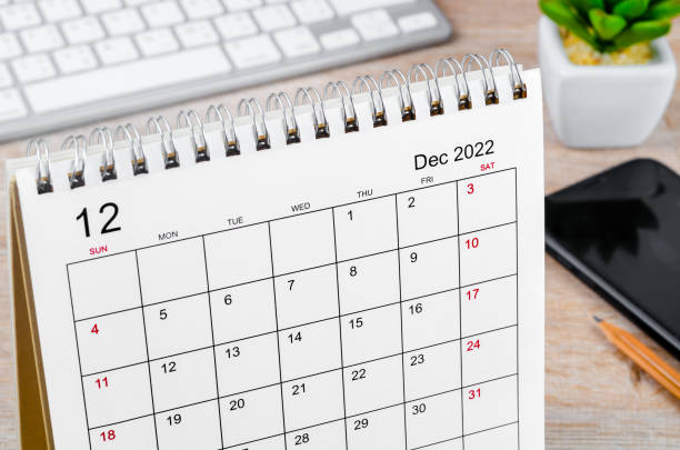 istock December 2022 desk calendar on wooden table. 1395341339