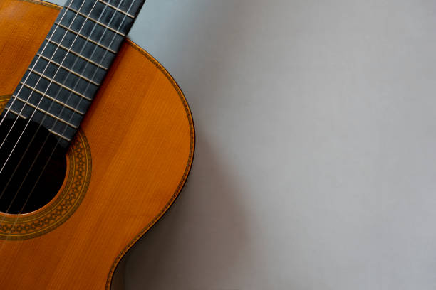 istock old classic guitar on gray table background, music concept 1395341870