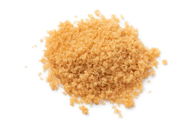 istock Heap of soft light brown sugar close up on white background 1395343014