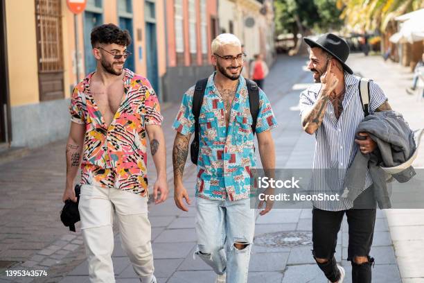 Three Happy Young Men Walking In The City Talking To Each Other Having Fun Multiethnic Group Of Friends Stock Photo - Download Image Now