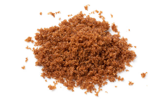 istock Heap of soft dark brown sugar close up on white background 1395343593
