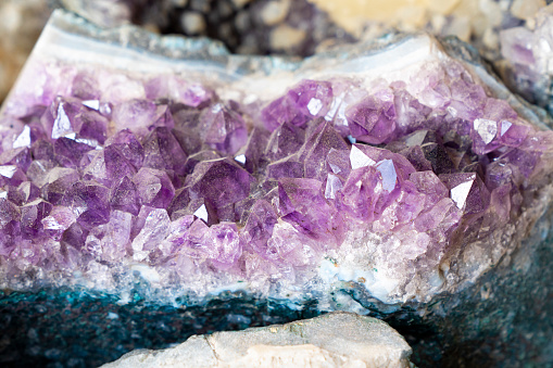 Close up on an amethyst geode. Amethyst druse over agate rock