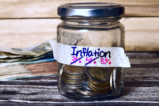 a mason jar with money and rising inflation - coin cheap jar currency imagens e fotografias de stock