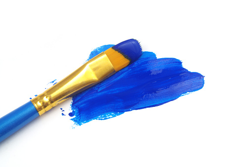 Blue paintbrush with blue paint isolated on white background