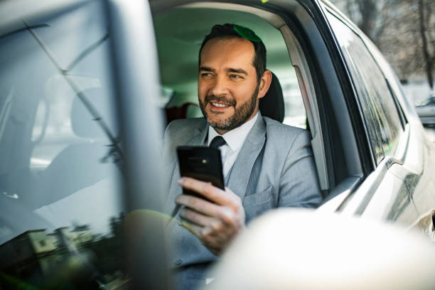 istock Businessman Driving to office using phone 1395345980