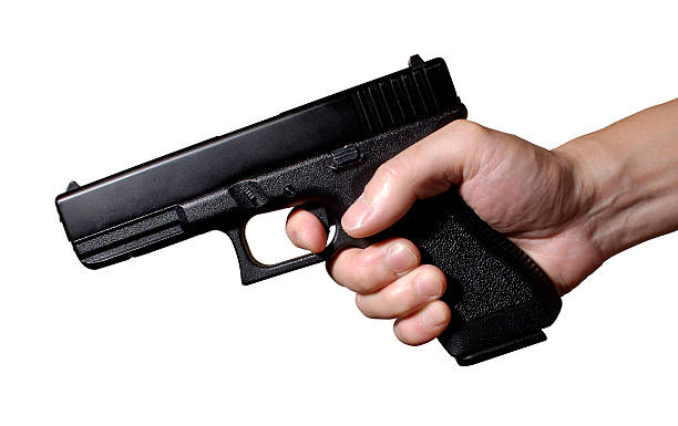 hand gun firing stock photo