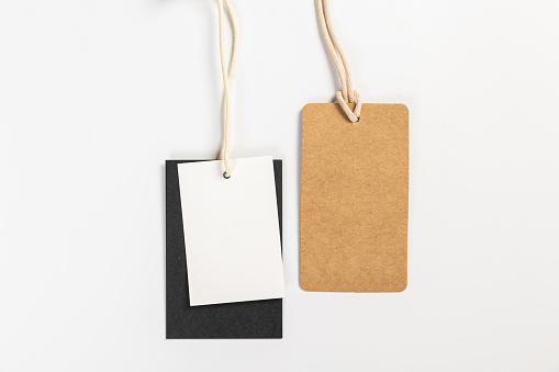 two fashionable blank labels for clothes on a gray background