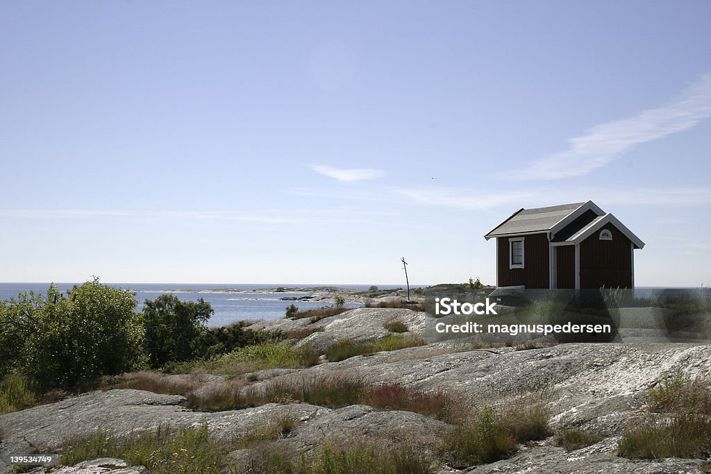 The swedish archipelago A little red cabin located at the island Huvudskär, Stockholm, Sweden. A beautiful view over the swedish archipelago. Archipelago Stock Photo